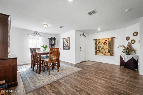 a view of a dining room with furniture and wooden floor