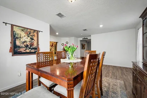 a dining room with furniture and wooden floor