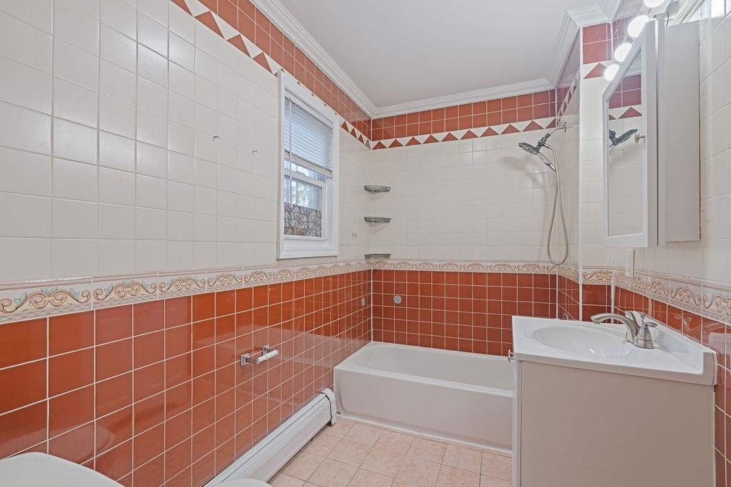 337 Summit Avenue, Unit 1 Jersey City, NJ 07306 - Photo 11 of 26 a bathroom with a bathtub and a sink