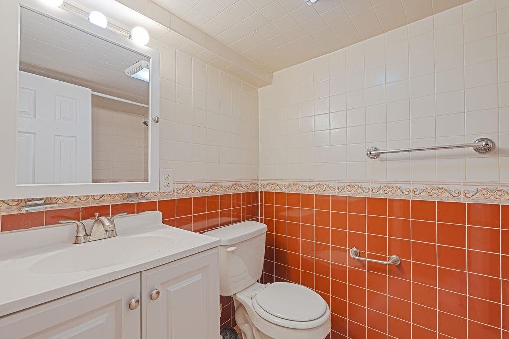 337 Summit Avenue, Unit 1 Jersey City, NJ 07306 - Photo 16 of 26 a bathroom with a sink a toilet a mirror and shower