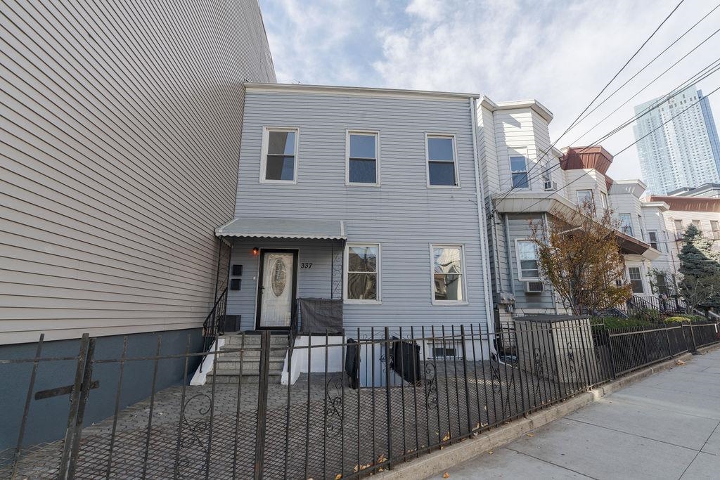 337 Summit Avenue, Unit 1 Jersey City, NJ 07306 - Photo 24 of 26 a view of a brick house with many windows
