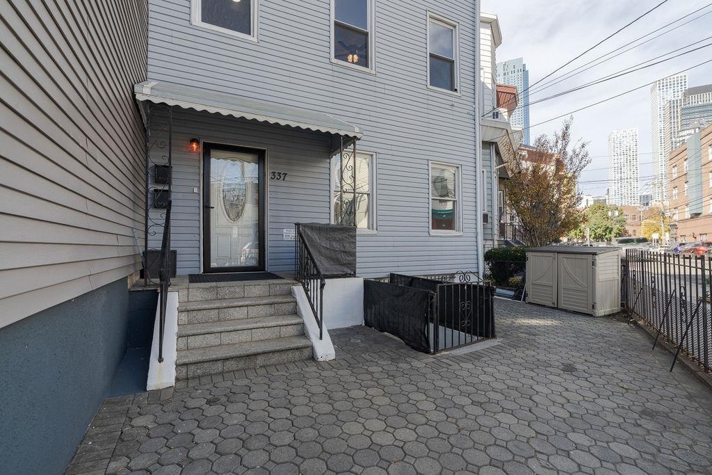 337 Summit Avenue, Unit 1 Jersey City, NJ 07306 - Photo 25 of 26 a view of a patio with table and chairs in a patio