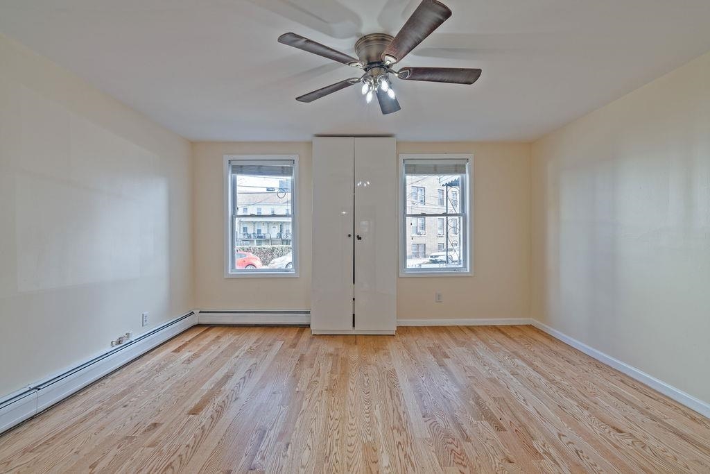 337 Summit Avenue, Unit 1 Jersey City, NJ 07306 - Photo 8 of 26 a view of empty room with wooden floor and fan
