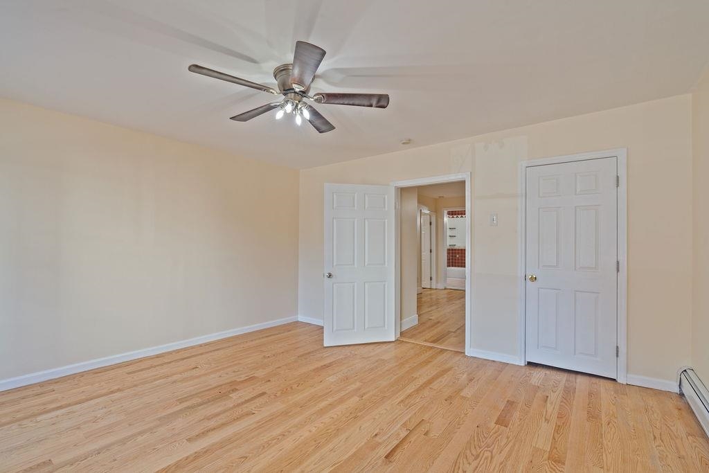 337 Summit Avenue, Unit 1 Jersey City, NJ 07306 - Photo 9 of 26 a view of a room with wooden floor and white walls