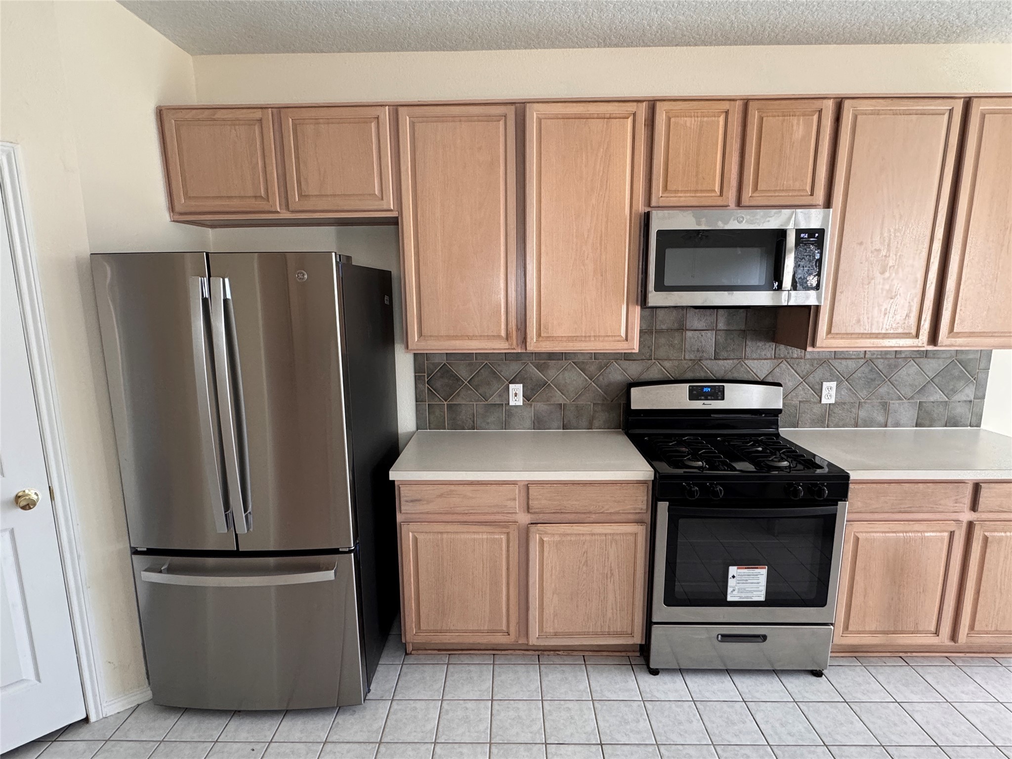 11011 Hunting Path Court Houston, TX 77065 - Photo 11 of 31 a kitchen with a refrigerator sink and microwave