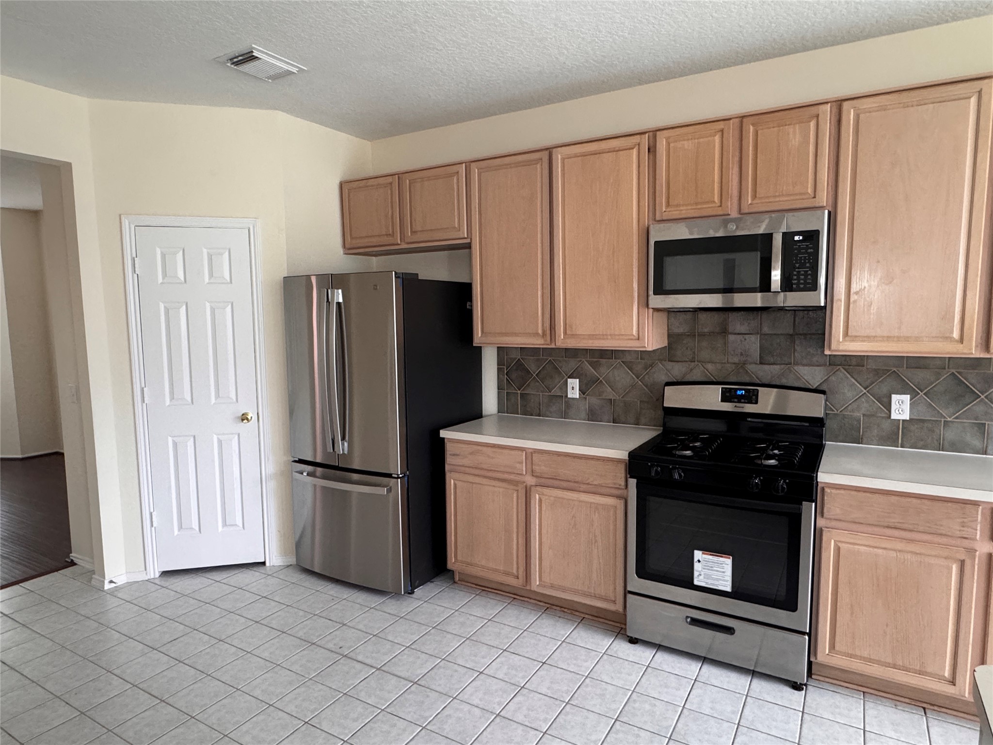 11011 Hunting Path Court Houston, TX 77065 - Photo 12 of 31 a kitchen with a refrigerator stove and microwave