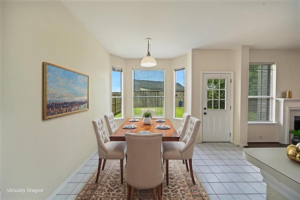 11011 Hunting Path Court Houston, TX 77065 - Photo 14 of 31 a dining room with furniture a chandelier and wooden floor