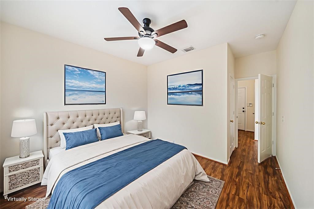11011 Hunting Path Court Houston, TX 77065 - Photo 16 of 31 a bedroom with a large bed and a ceiling fan