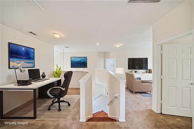 a view of a livingroom with workspace and a couch