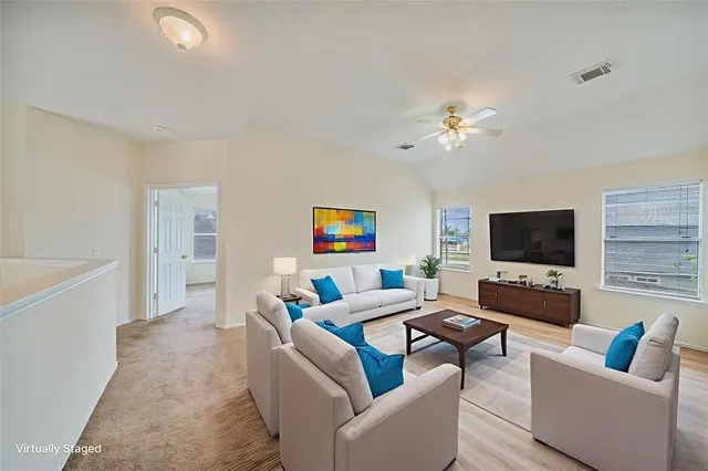 a living room with furniture and a flat screen tv