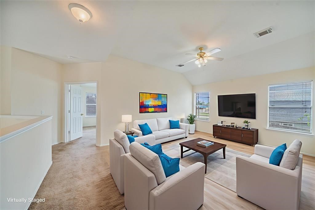 11011 Hunting Path Court Houston, TX 77065 - Photo 23 of 31 a living room with furniture and a flat screen tv