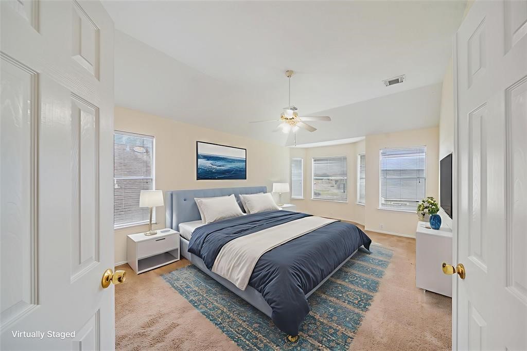 11011 Hunting Path Court Houston, TX 77065 - Photo 26 of 31 a spacious bedroom with a bed and a chandelier