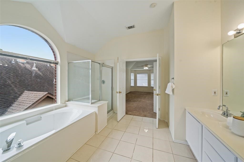 11011 Hunting Path Court Houston, TX 77065 - Photo 28 of 31 a spacious bathroom with a granite countertop sink a mirror and a shower