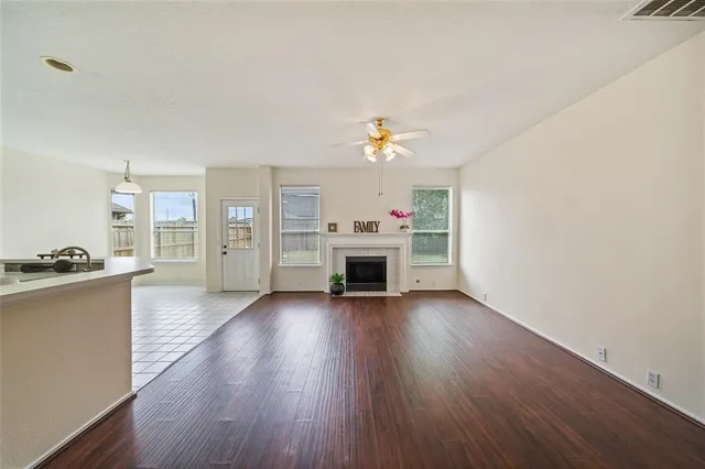a view of a livingroom with a fireplace and wooden floor