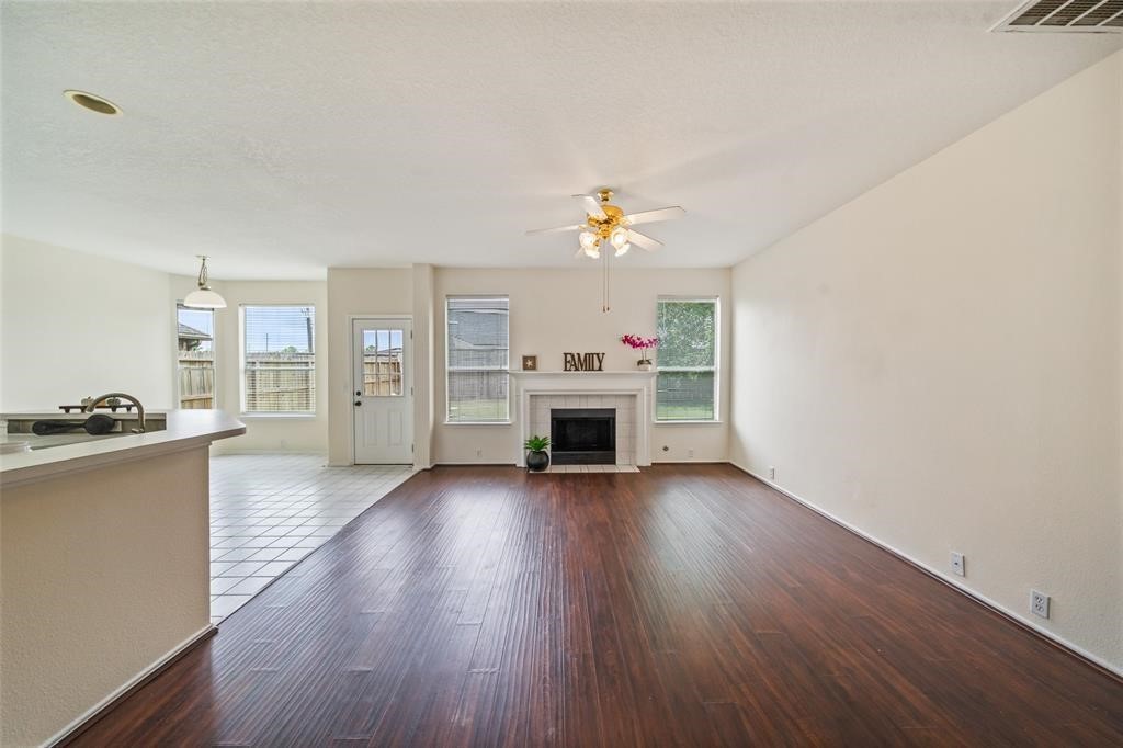 11011 Hunting Path Court Houston, TX 77065 - Photo 5 of 31 a view of a livingroom with a fireplace and wooden floor
