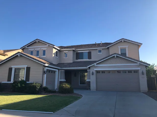 a front view of a house with a yard and garage