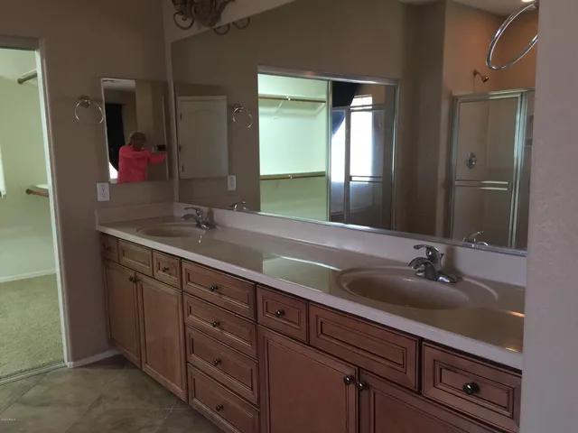 a bathroom with a double vanity sink and a mirror
