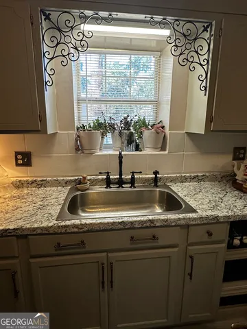 a kitchen with a sink and a window