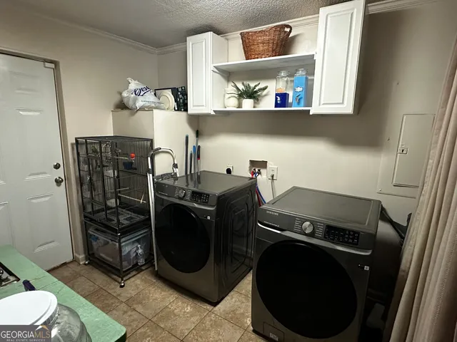 a utility room with sink dryer and washer
