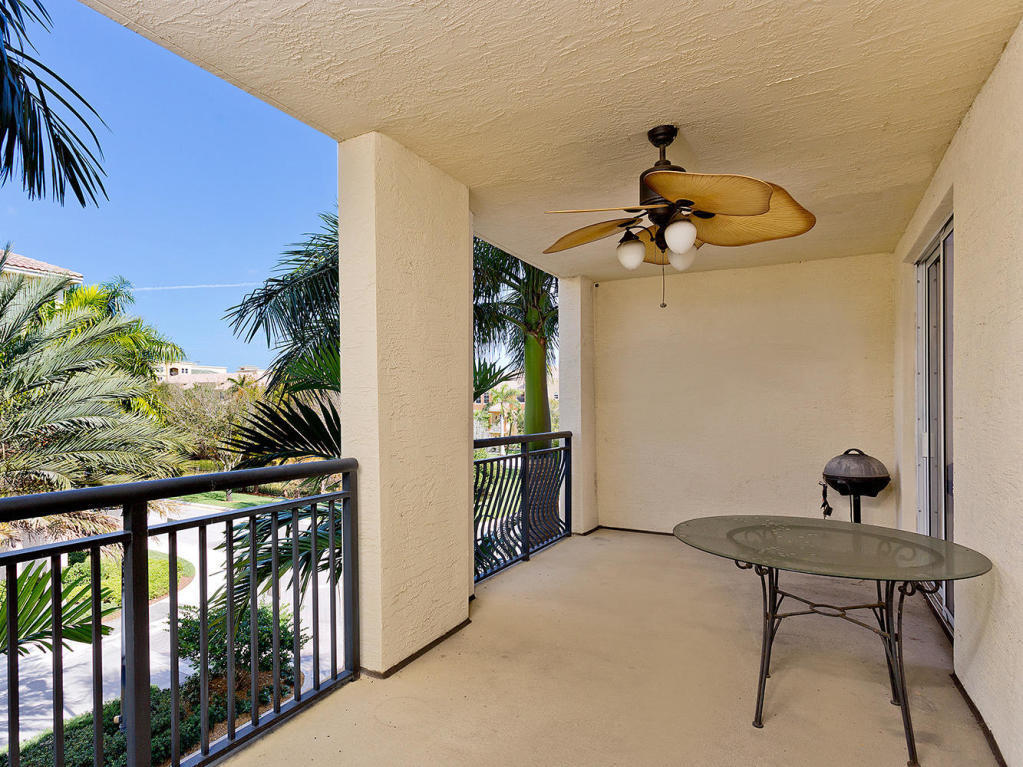 4 Renaissance Way, Unit 303 Boynton Beach, FL 33426 - Photo 13 of 26 a bedroom with a bed and a chandelier