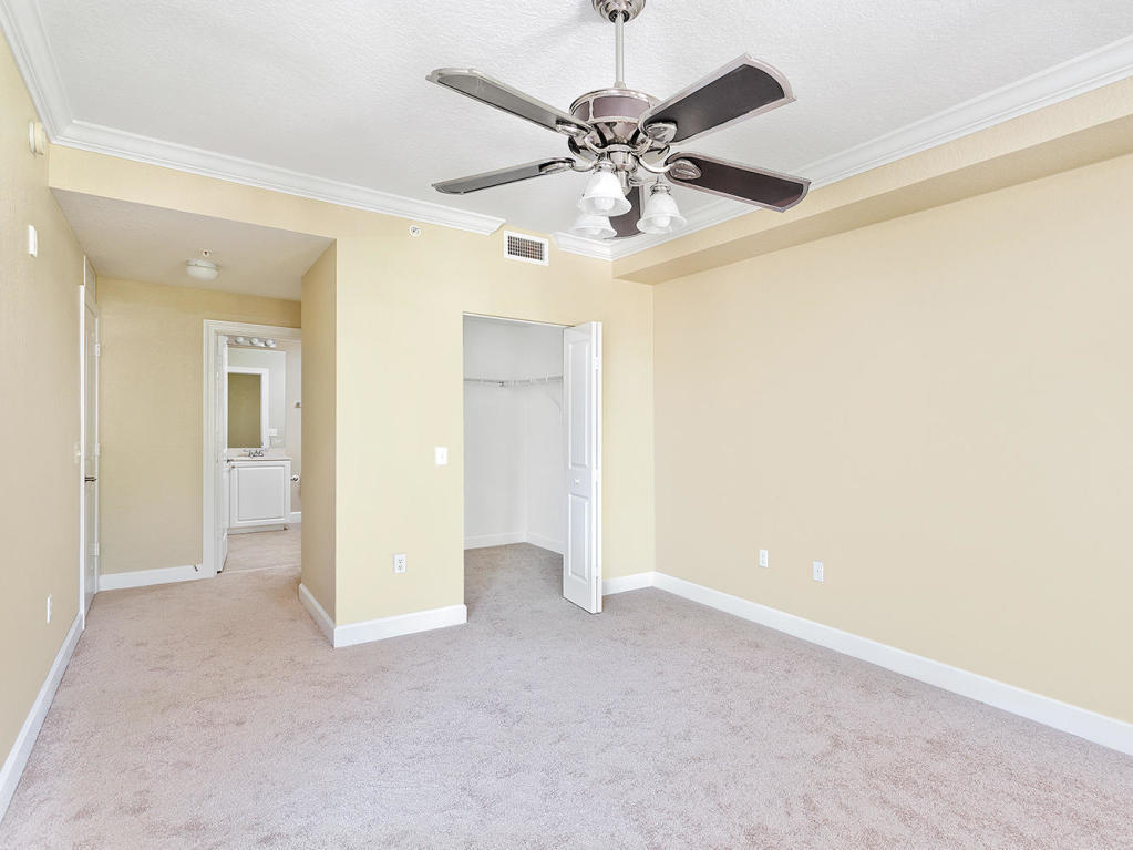 4 Renaissance Way, Unit 303 Boynton Beach, FL 33426 - Photo 16 of 26 wooden floor in an empty room and a chandelier fan