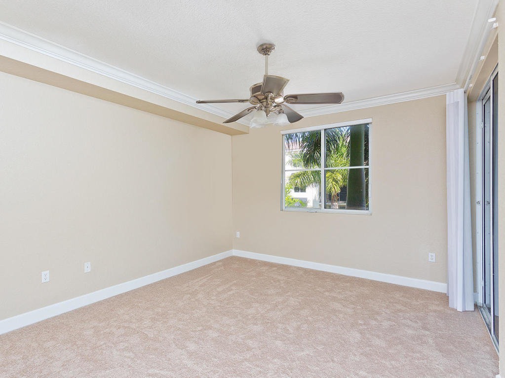 4 Renaissance Way, Unit 303 Boynton Beach, FL 33426 - Photo 17 of 26 en empty room with windows and ceiling fan