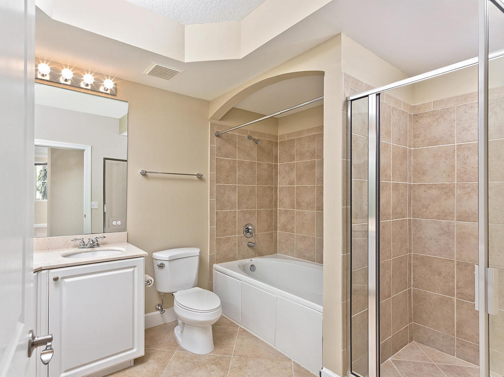 4 Renaissance Way, Unit 303 Boynton Beach, FL 33426 - Photo 18 of 26 a bathroom with a toilet a sink and bathtub