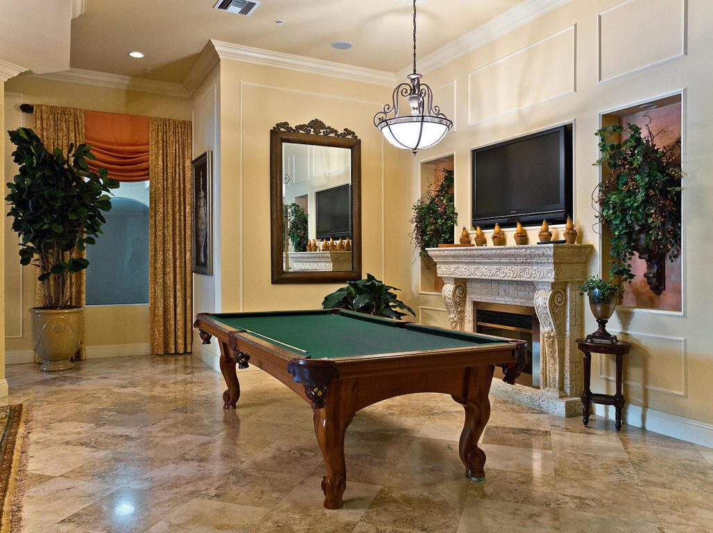 4 Renaissance Way, Unit 303 Boynton Beach, FL 33426 - Photo 25 of 26 a room with furniture a flat screen tv and a fireplace