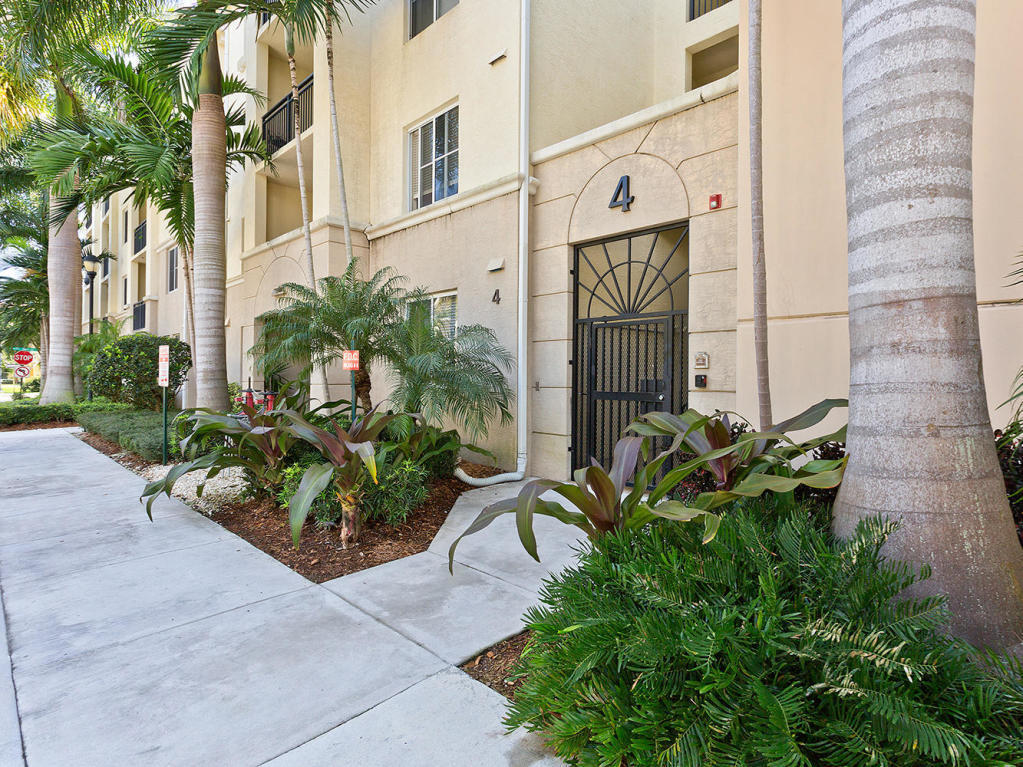 4 Renaissance Way, Unit 303 Boynton Beach, FL 33426 - Photo 4 of 26 a front view of a multi story residential apartment building with yard