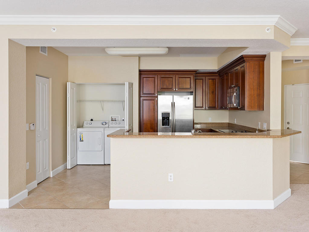 4 Renaissance Way, Unit 303 Boynton Beach, FL 33426 - Photo 7 of 26 a living room with a refrigerator and dresser