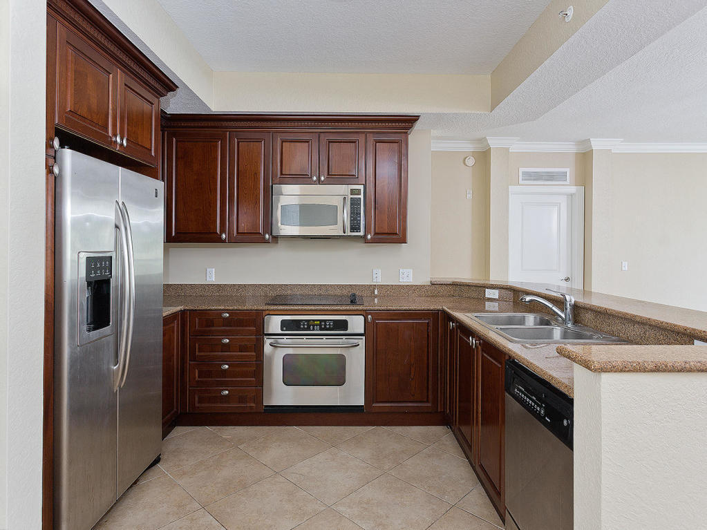 4 Renaissance Way, Unit 303 Boynton Beach, FL 33426 - Photo 8 of 26 a kitchen with stainless steel appliances granite countertop a refrigerator stove and sink