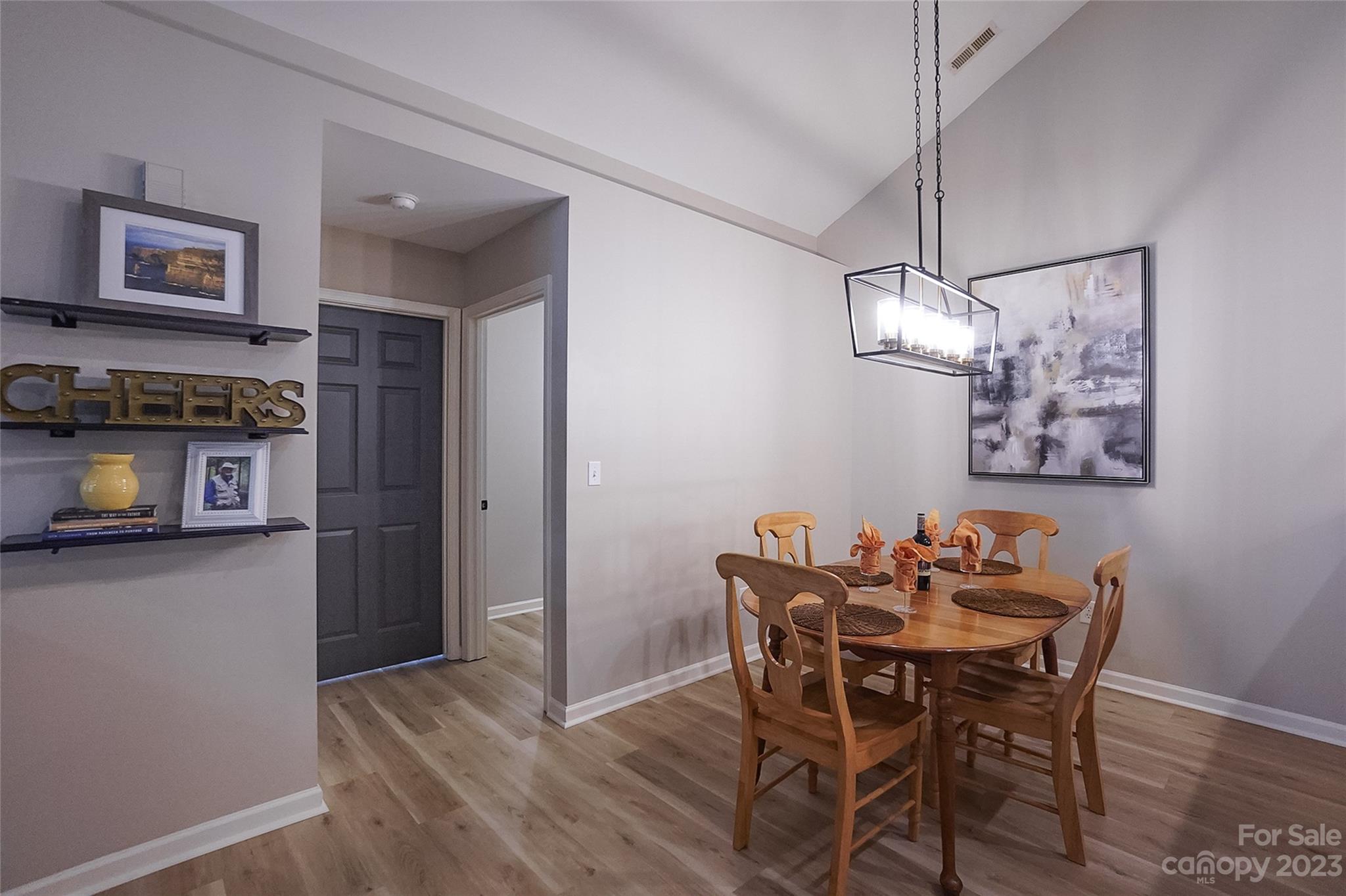 815 Ledgestone Court Tega Cay, SC 29708 - Photo 13 of 39 a dining room with furniture a chandelier and wooden floor