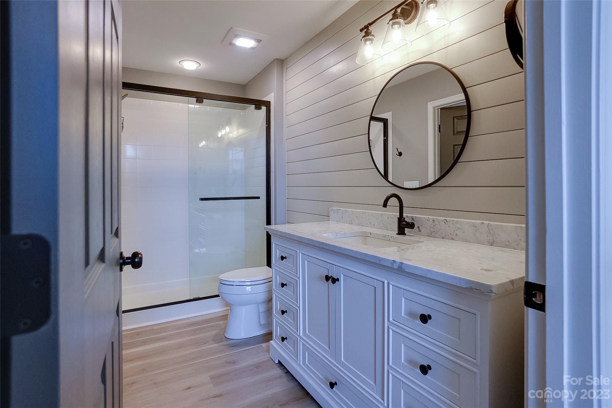 815 Ledgestone Court Tega Cay, SC 29708 - Photo 24 of 39 a bathroom with a granite countertop toilet sink and mirror