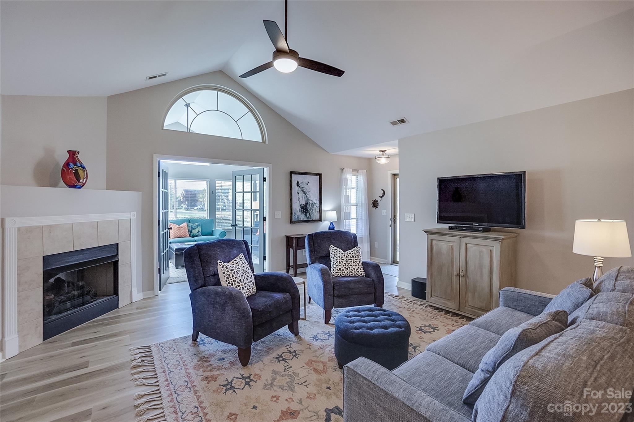 815 Ledgestone Court Tega Cay, SC 29708 - Photo 7 of 39 a living room with furniture a fireplace and a flat screen tv
