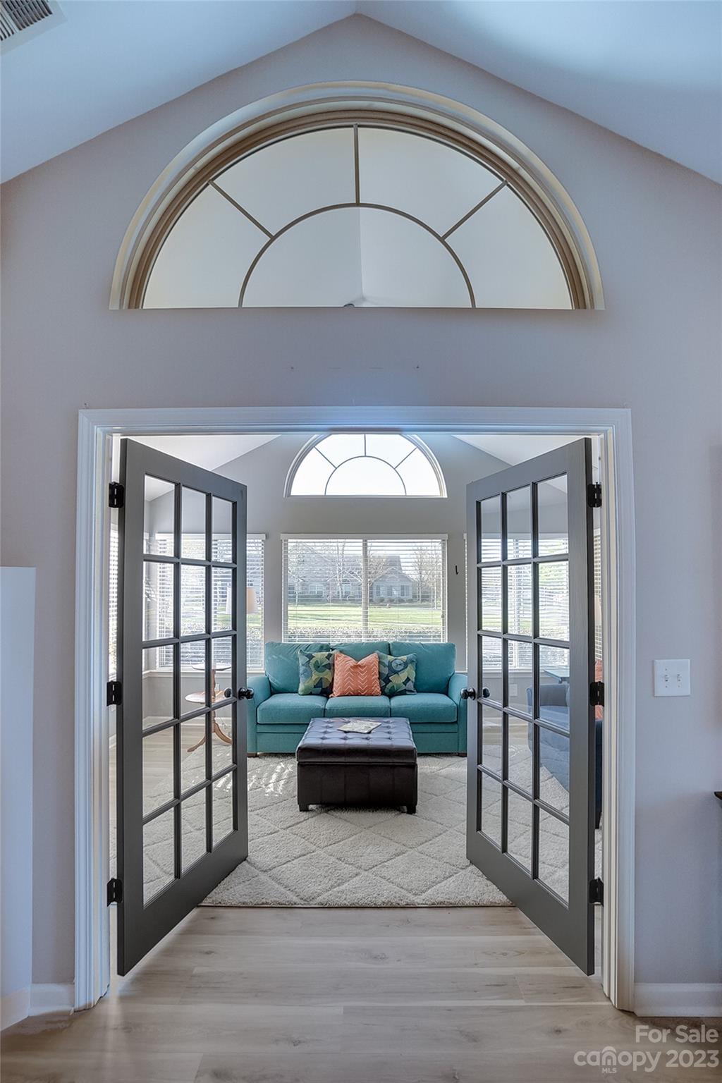 815 Ledgestone Court Tega Cay, SC 29708 - Photo 10 of 39 a living room with a large window and a wooden floor