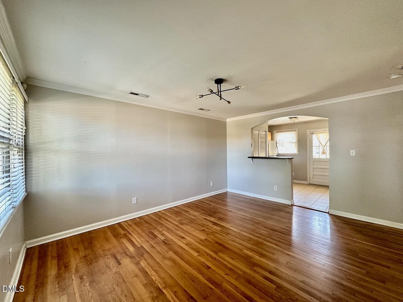 2333 Bernard Street Raleigh, NC 27608 - Photo 11 of 19 an empty room with wooden floor and windows