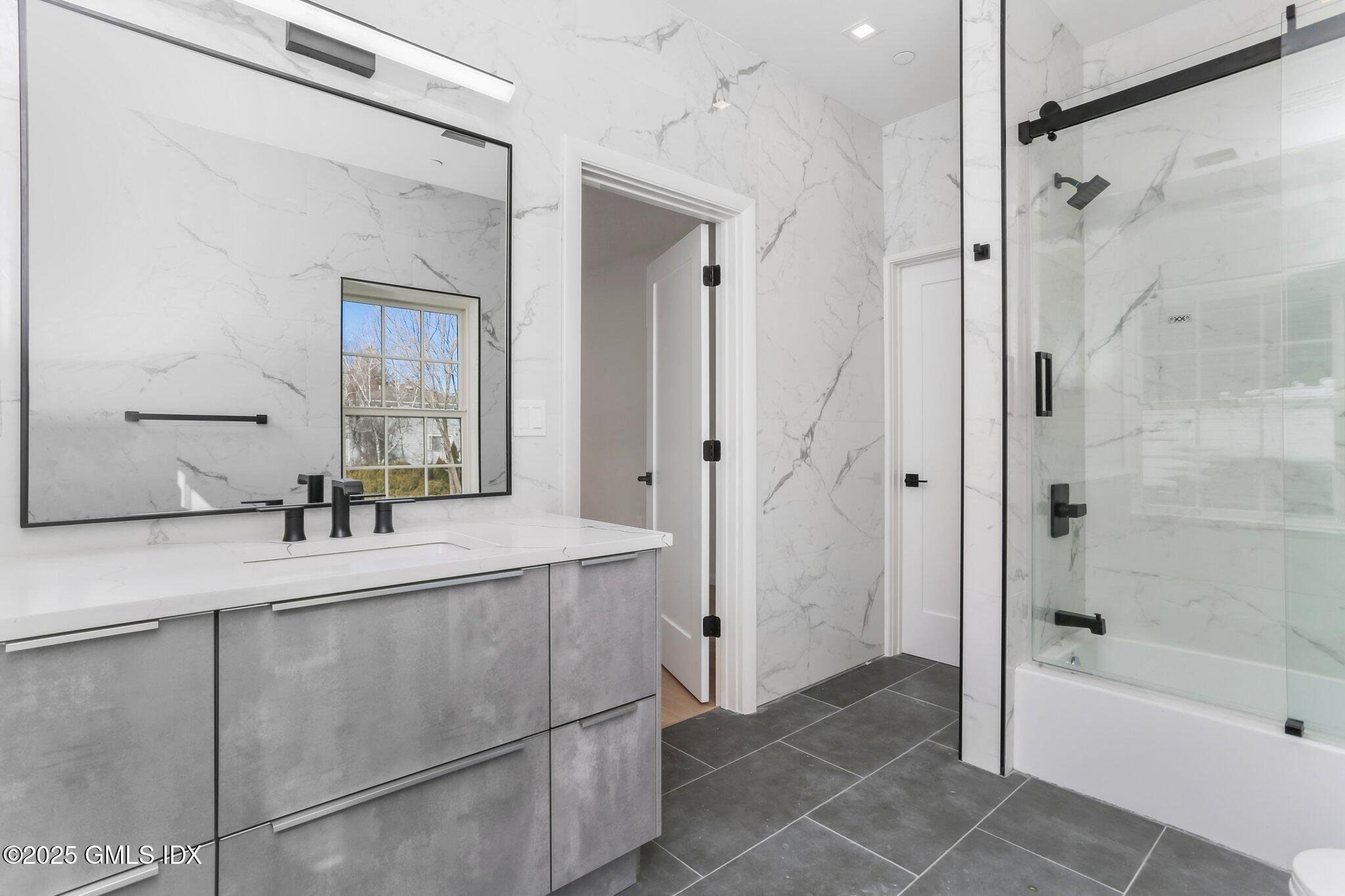 63 Church Street, Unit 2R Greenwich, CT 06830 - Photo 11 of 13 a bathroom with a tub sink and mirror