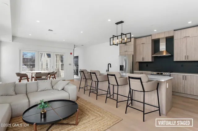 a living room with furniture a rug and a chandelier