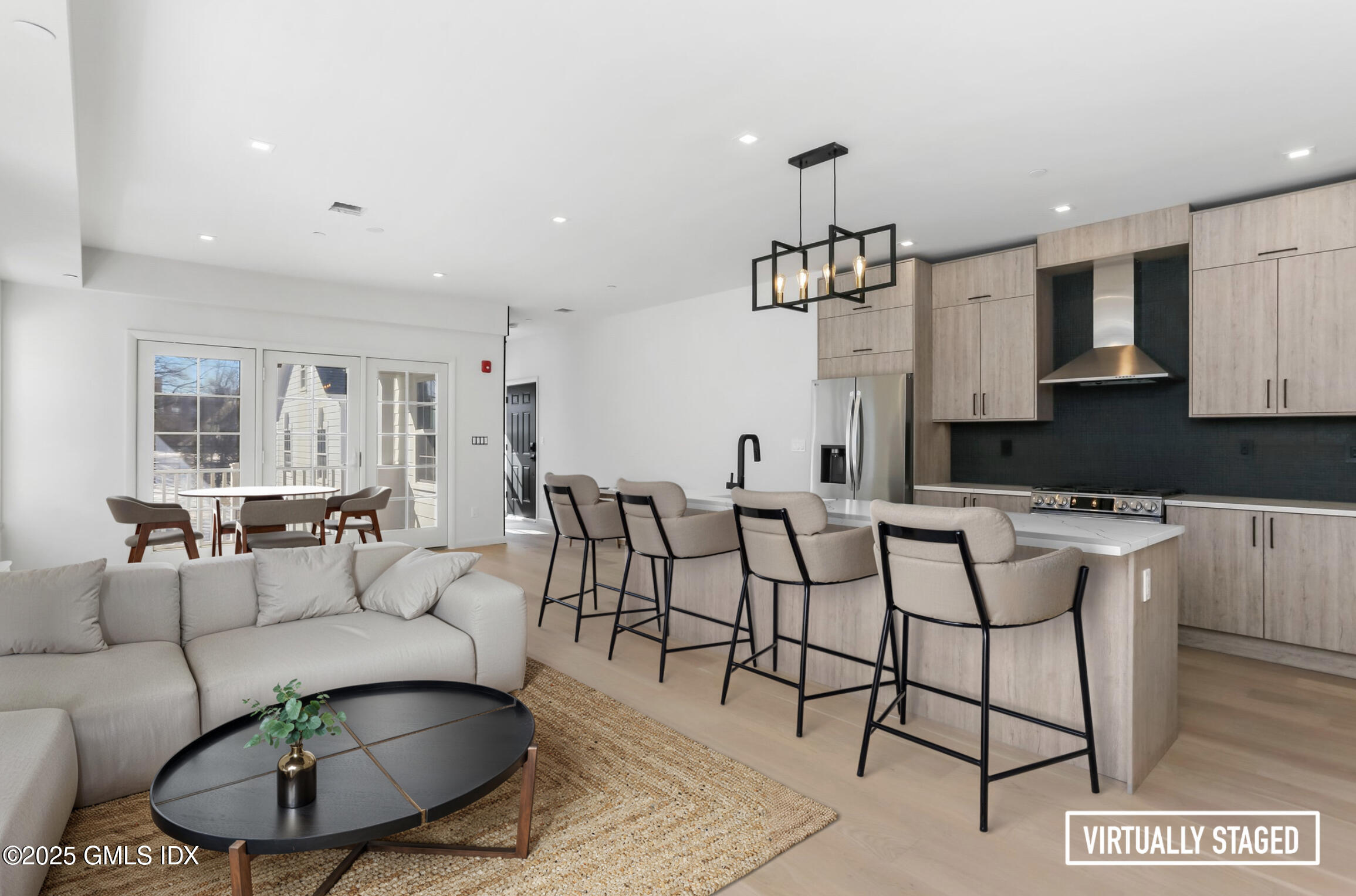 63 Church Street, Unit 2R Greenwich, CT 06830 - Photo 2 of 13 a living room with furniture a rug and a chandelier