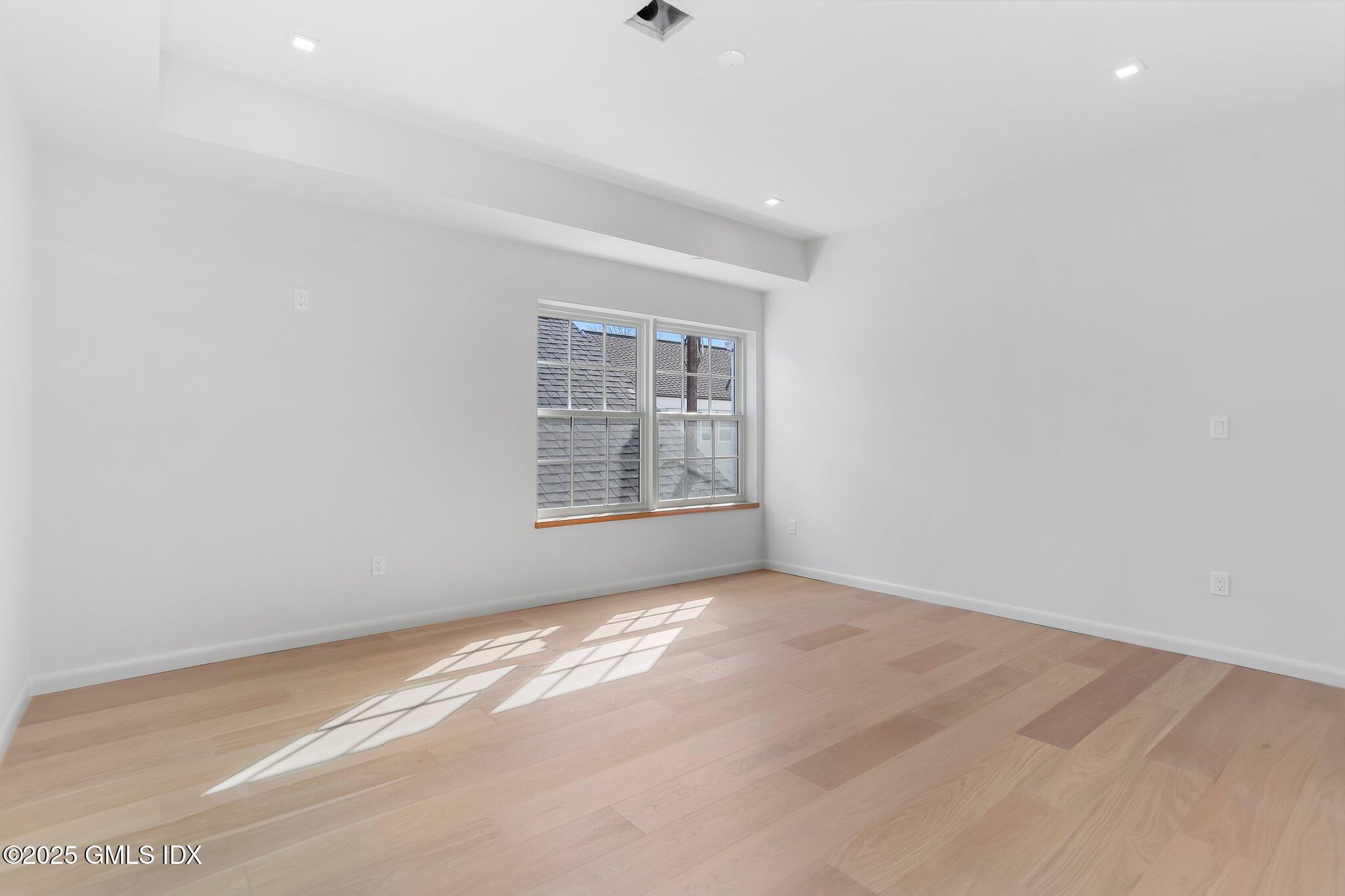 63 Church Street, Unit 2R Greenwich, CT 06830 - Photo 10 of 13 an empty room with windows