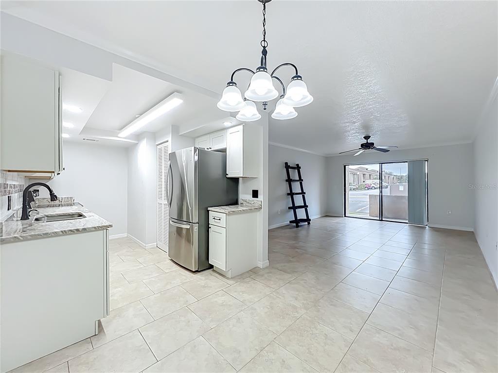 5249 Vineland Road Orlando, FL 32811 - Photo 14 of 42 a view of a kitchen with a sink stainless steel appliances and cabinets