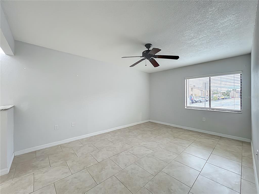 5249 Vineland Road Orlando, FL 32811 - Photo 18 of 42 a view of a room with a ceiling fan and window