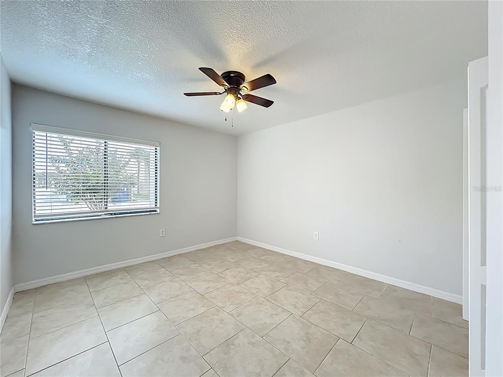 5249 Vineland Road Orlando, FL 32811 - Photo 29 of 42 a view of an empty room with a ceiling fan