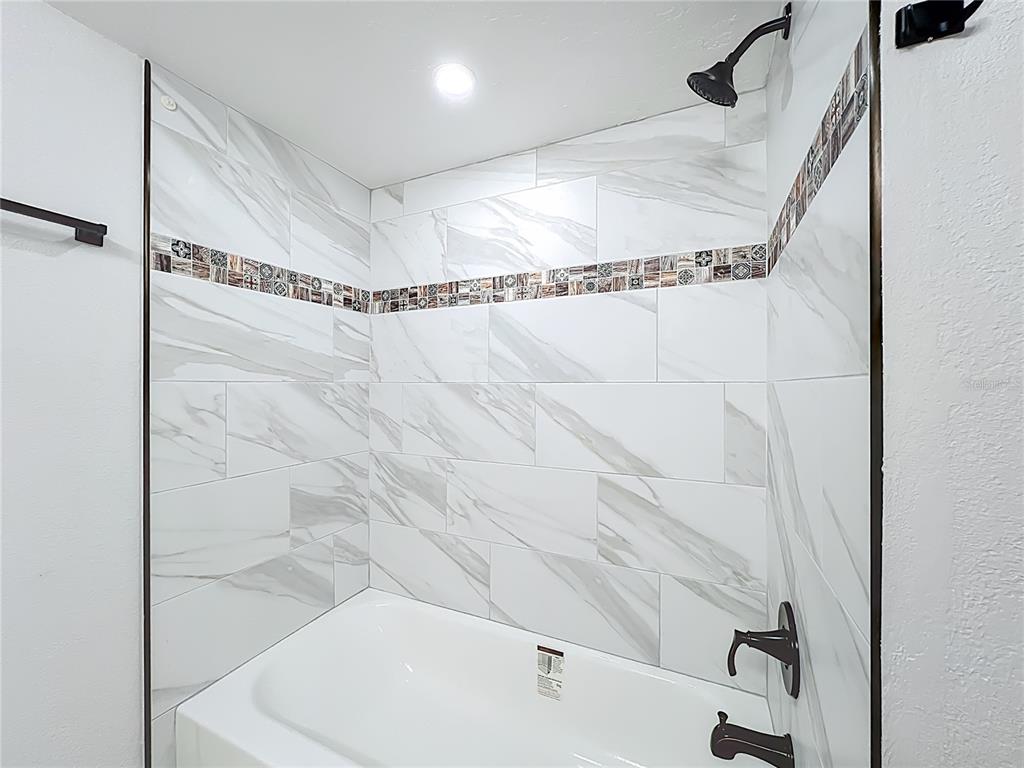 5249 Vineland Road Orlando, FL 32811 - Photo 33 of 42 a bathroom with a bathtub and a shower