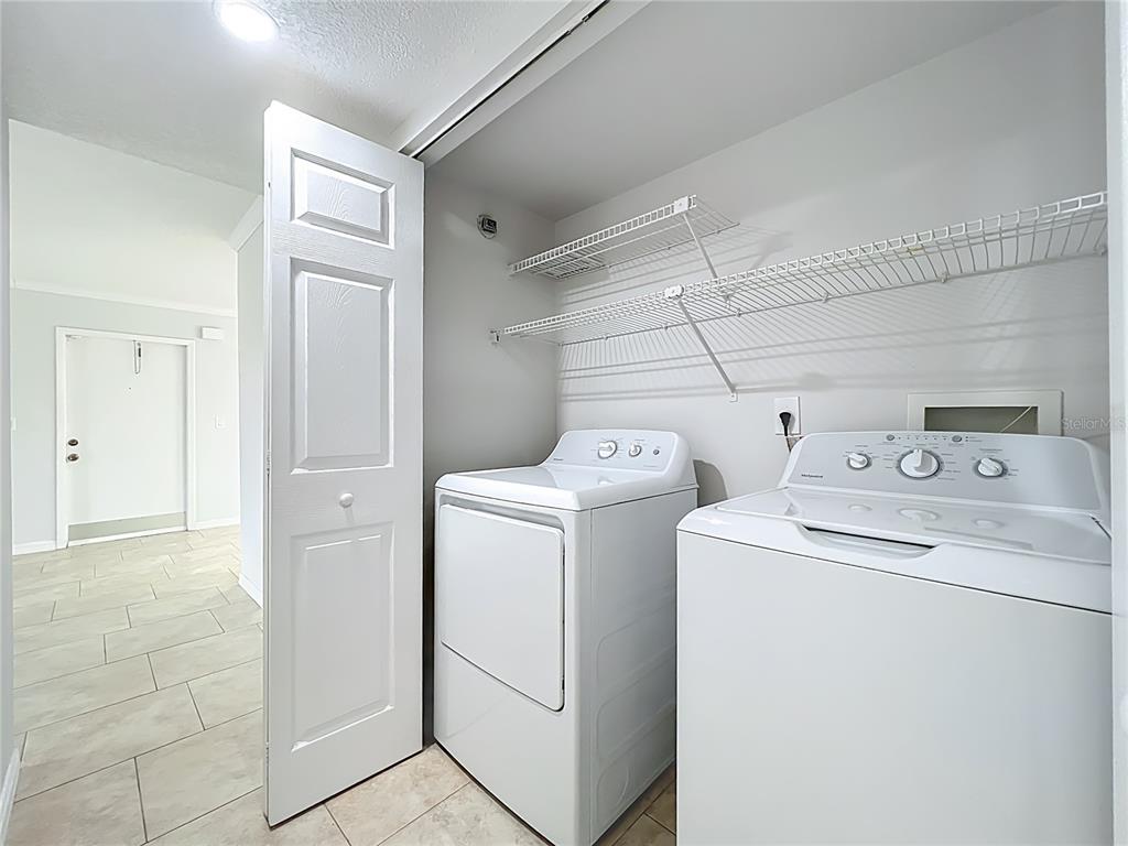 5249 Vineland Road Orlando, FL 32811 - Photo 35 of 42 a utility room with dryer and washer