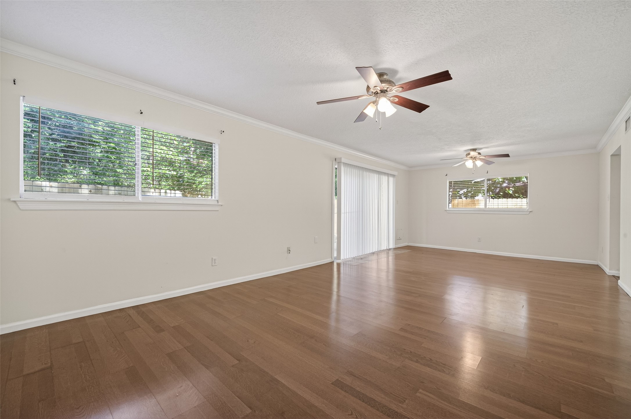 1106 East Red Cedar Circle Spring, TX 77380 - Photo 11 of 43 a view of an empty room with wooden floor and a window