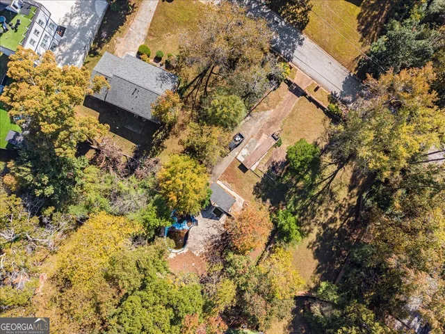 an aerial view of residential house with parking and yard