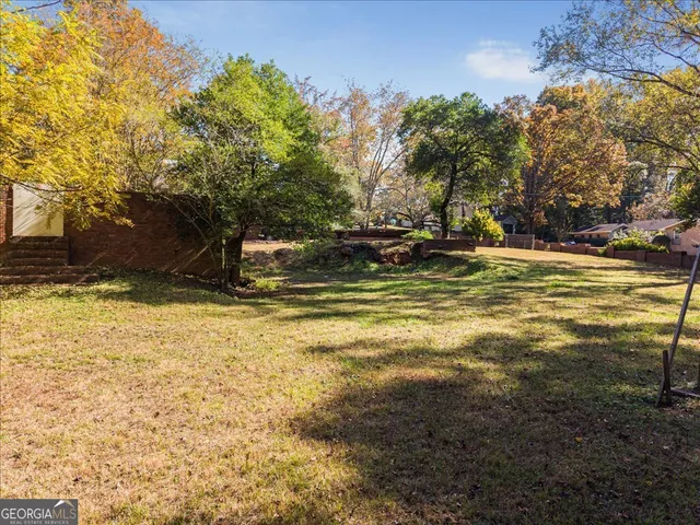 a view of a swimming pool with an outdoor space and seating area