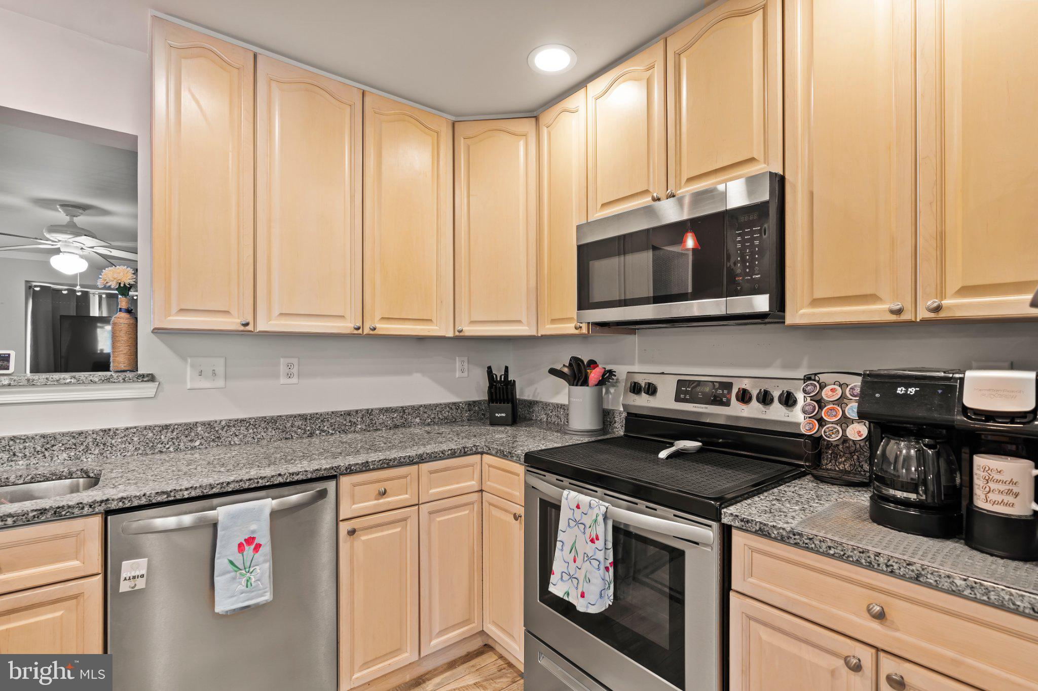 128 Sentry Ridge Smithsburg, MD 21783 - Photo 5 of 41 a kitchen with stainless steel appliances granite countertop a stove a sink and a microwave