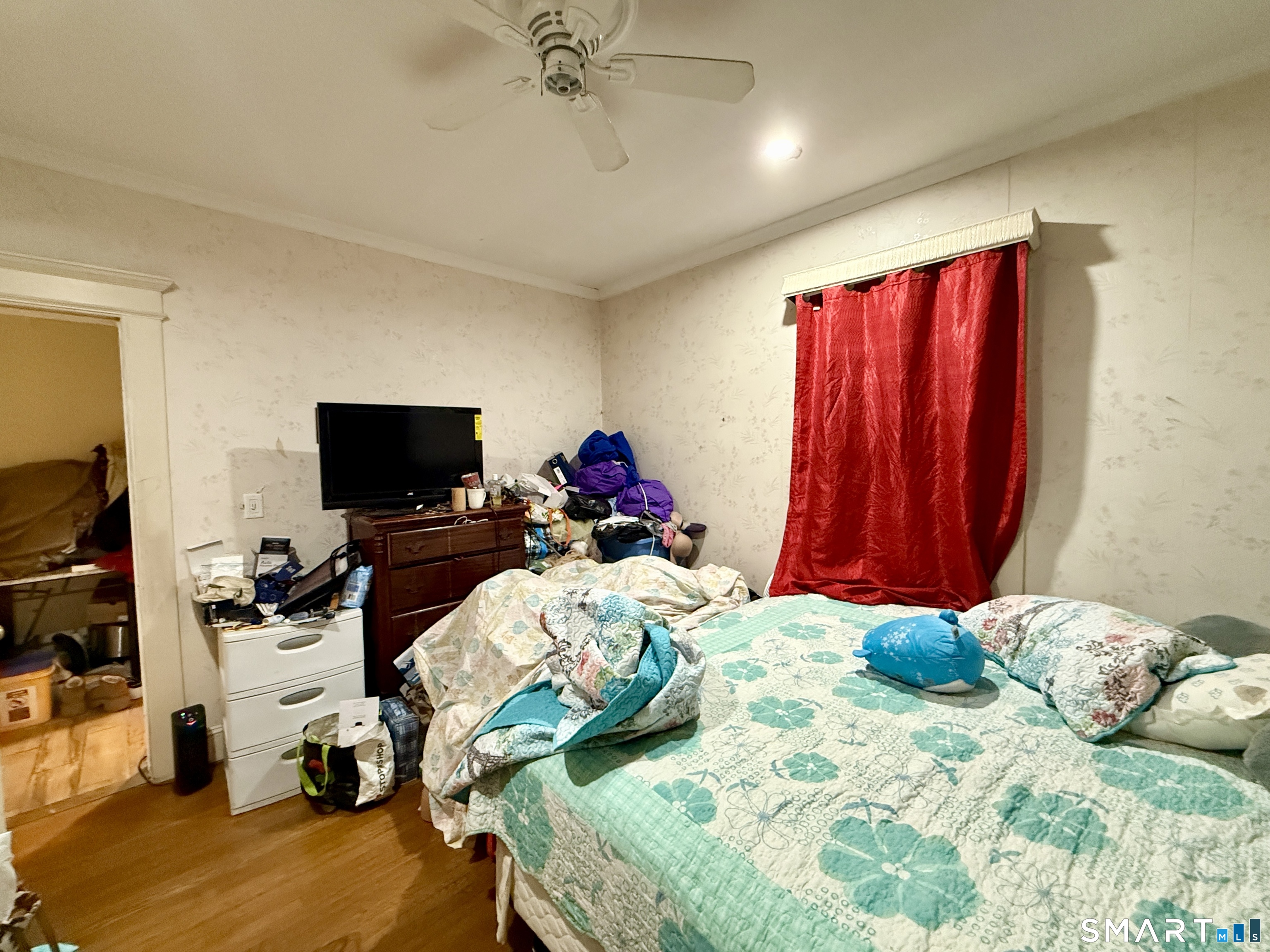 26 Victory Street Bridgeport, CT 06606 - Photo 17 of 32 a bedroom with a bed and a television